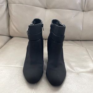 Ankle bootie from Unisa with C-shaped buckles and exposed zipper in silver.